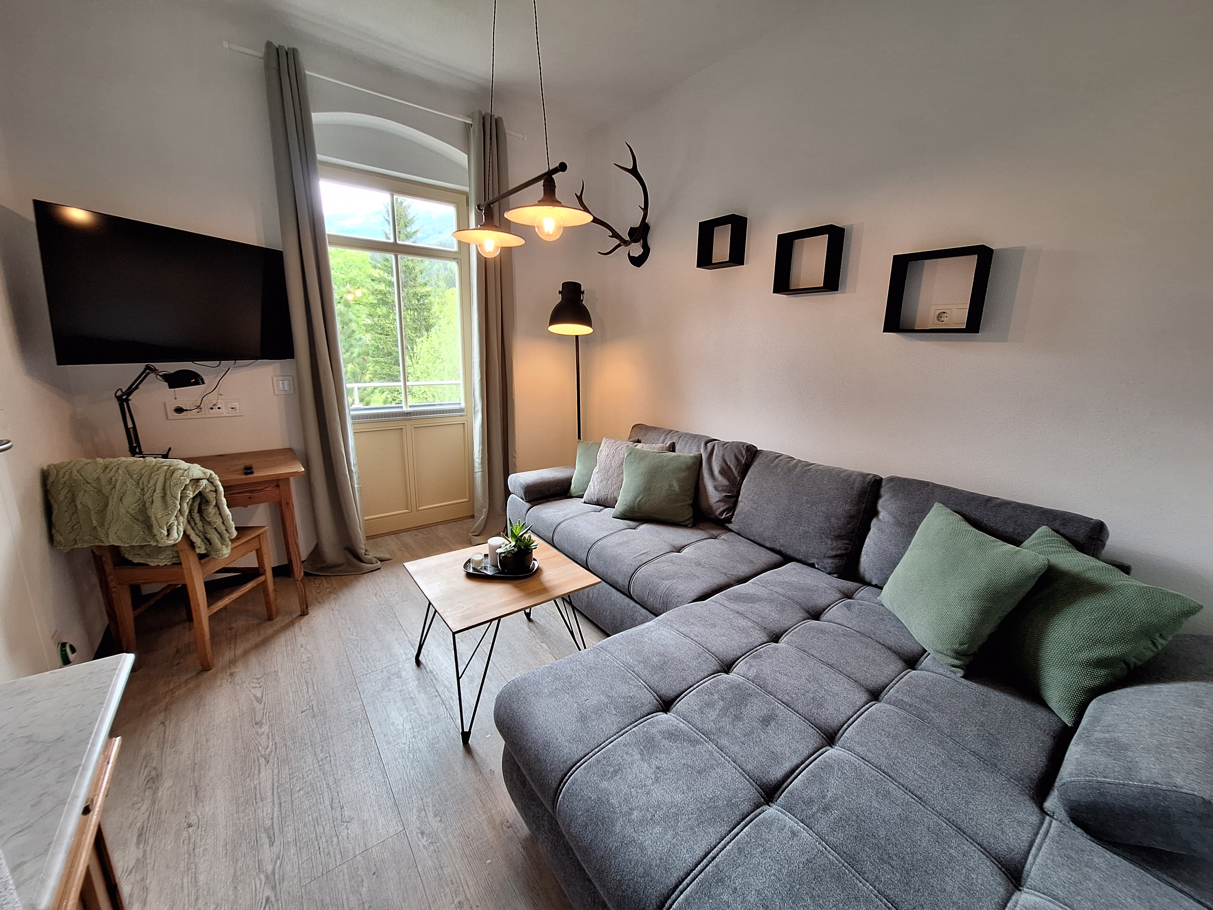 Living room with TV and access to the balcony.